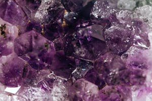 Detailed macro shot of natural amethyst crystals highlighting textures and purple hues.